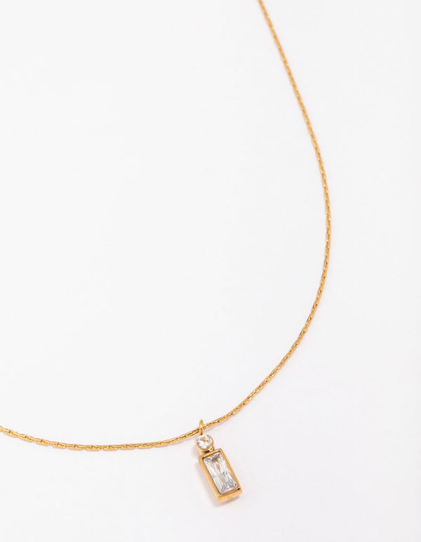 Showcasing a waterproof thin pendant necklace with baguette and round stone cut crafted from cubic zirconia, gold plated stainless steel close up view