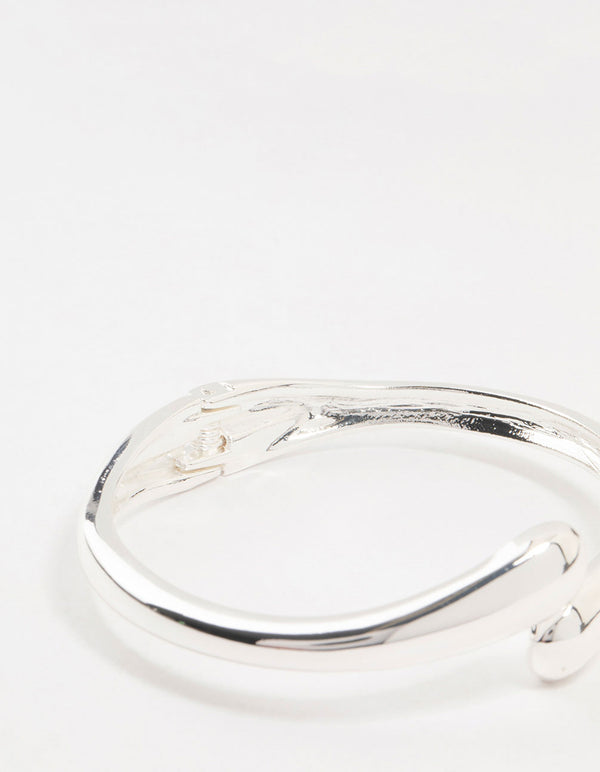 Highlighting the silver plated open hinge wrapped bracelet and closure mechanism closure detail view