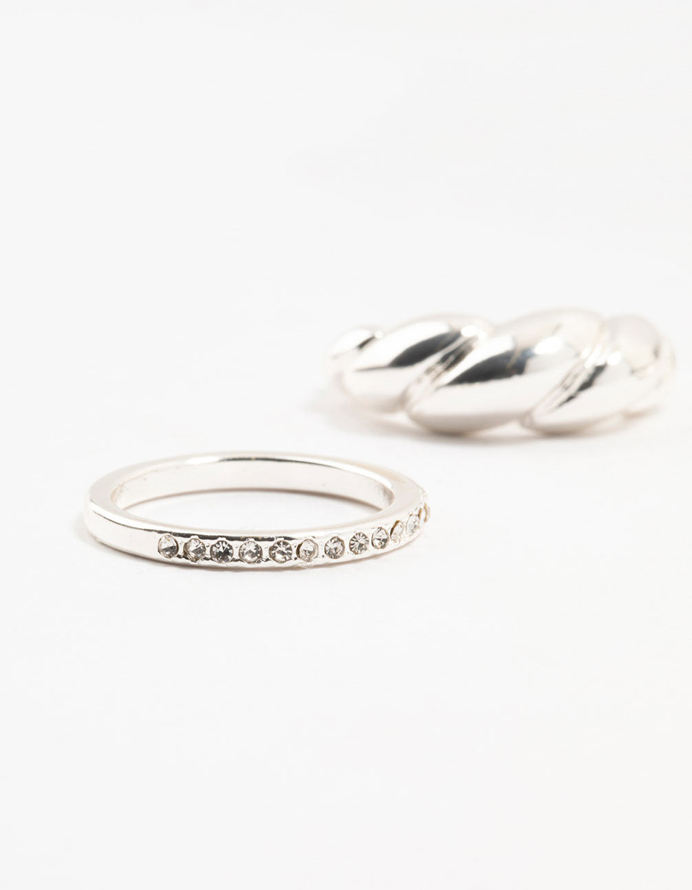 Showcasing silver plated diamante twisted ring pack with stackable design close up view