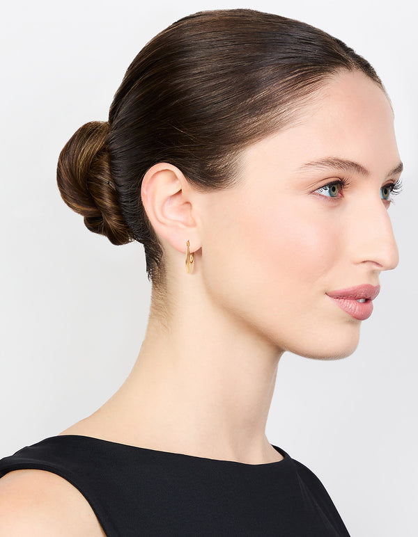 Elegant waterproof elongated flat hoop earrings in gold plated stainless steel on model view