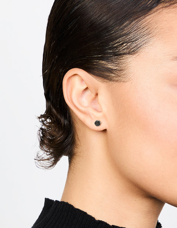 Featuring waterproof black diamante stainless steel stud earrings on ear view