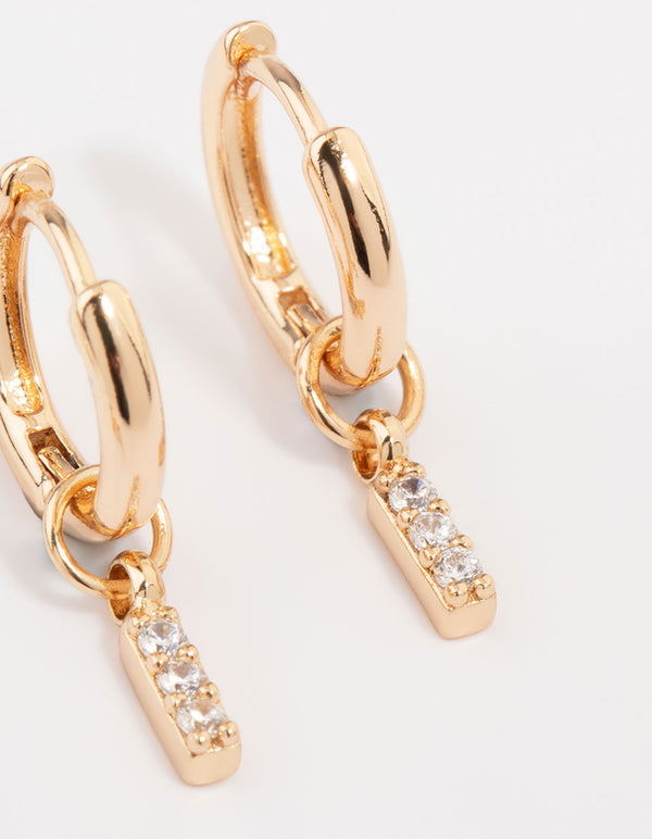 Elegant gold cubic zirconia heart and twisted huggie earrings in a 3-pack with bar and charm accents close up view
