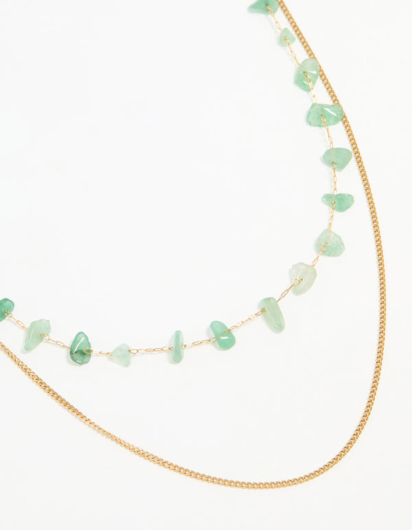 Showcasing a waterproof layered necklace with green stone beads, stainless steel construction and gold plated finish close up view