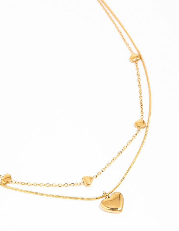 Beautifully designed waterproof gold plated stainless steel heart pendant layered necklace with charm accents close up view