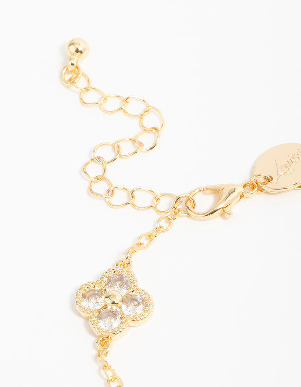 Featuring a gold plated cubic zirconia statement flower bracelet with charm detailing closure detail view