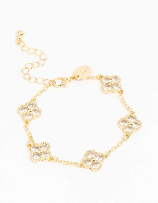 Showcasing a gold plated cubic zirconia statement flower bracelet with charm detailing front view