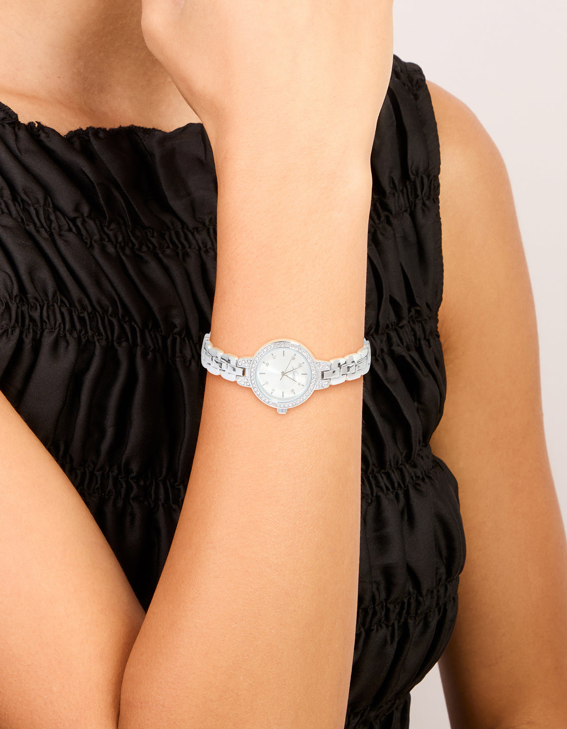 Elegant silver diamante small round strap watch with white dial stone look cubic zirconia link band designed for women formal occasions analog type on wrist view