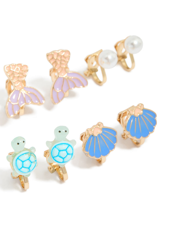 Showcasing kids turtle and mermaid clip on earrings in a 5-pack with ocean pearl and shell feature in gold lavender light blue mint cream close up view