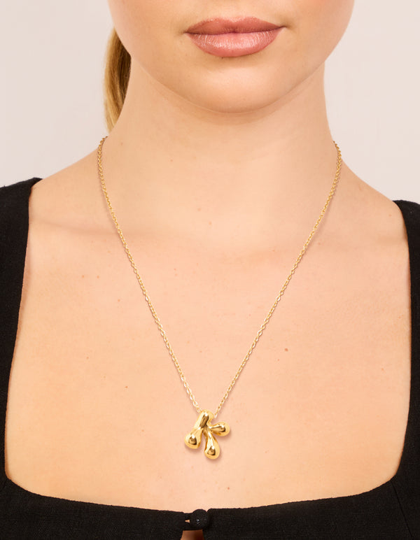 Featuring a waterproof large bubble letter K dainty necklace in gold plated stainless steel with initial pendant on neck view