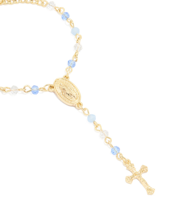 Showcasing a gold plated bracelet with blue beads featuring cross elements close up view