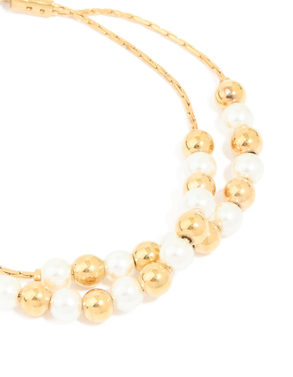 Close detail of waterproof gold plated stainless steel pearl and ball layered bracelet highlighting alternating beads close up view