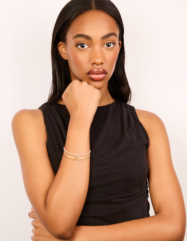 Designed with waterproof gold plated stainless steel diamante and snake chain layered bracelet on wrist view