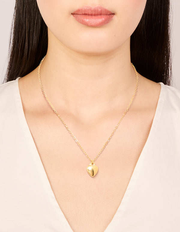 Showcasing a waterproof gold plated stainless steel puffy heart pendant necklace on neck view