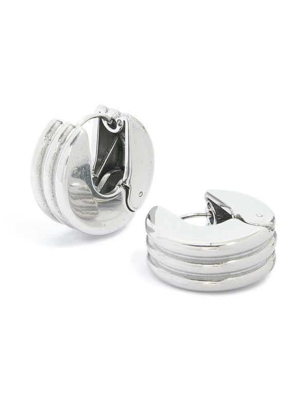Featuring waterproof stainless steel ribbed circle hinged hoop earrings in silver front view