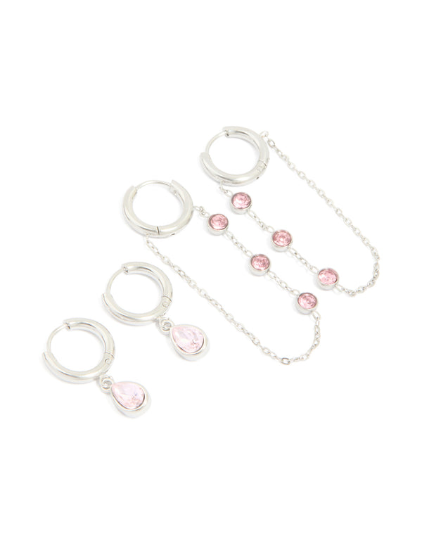 Showcasing waterproof stainless steel pink cubic zirconia chain droplet and classic huggie earrings 2-pack in silver and light pink tones on ear view