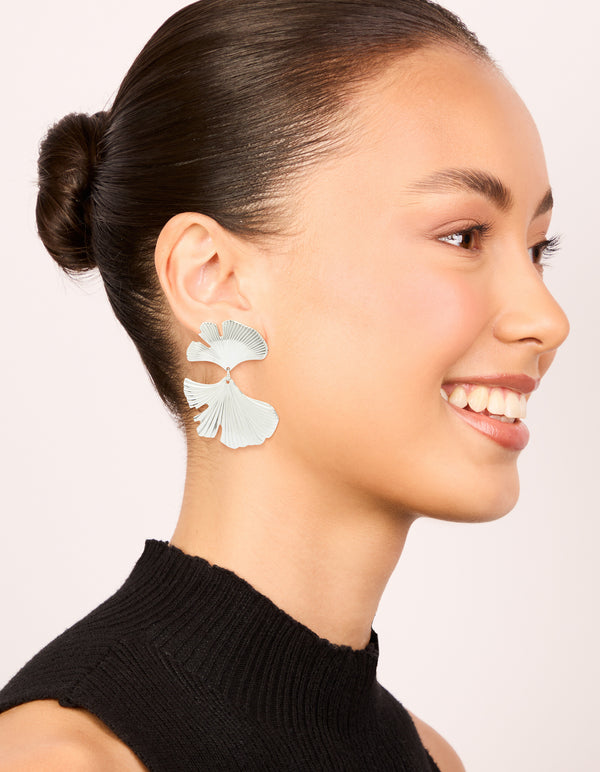Styled waterproof stainless steel statement petal earrings in silver on model view