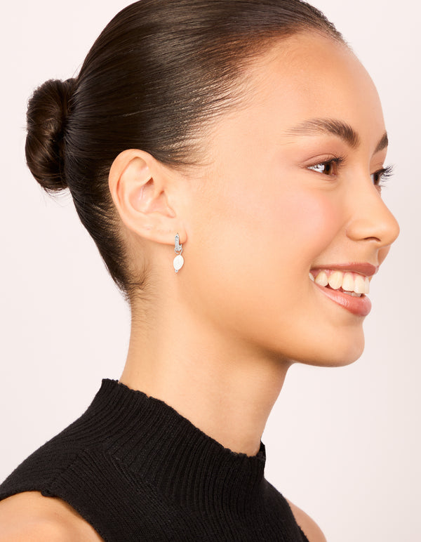 Waterproof stainless steel diamante freshwater pearl drop huggie earrings styled on model view