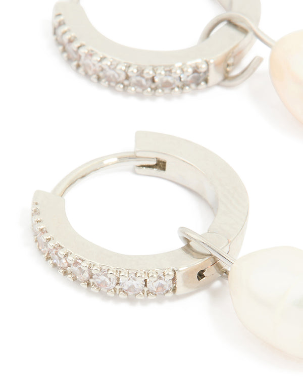Detailed view of pearl drop huggie earrings with diamante detailing and waterproof stainless steel construction close up view