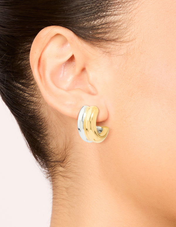 Featuring waterproof mixed metal plated stainless steel layered huggie earrings in gold and silver on ear view