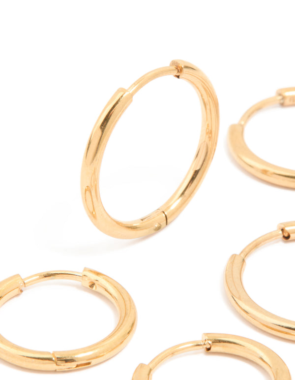 Highlighting waterproof gold plated stainless steel classic huggie clicker earrings in a 3-pack close up view