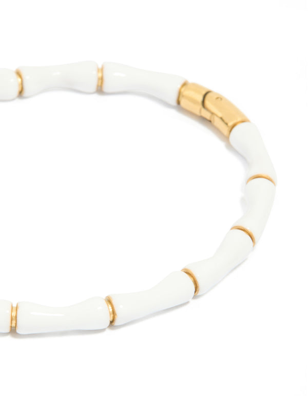 Discover a waterproof bamboo bangle crafted from gold plated stainless steel with white enamel close up view
