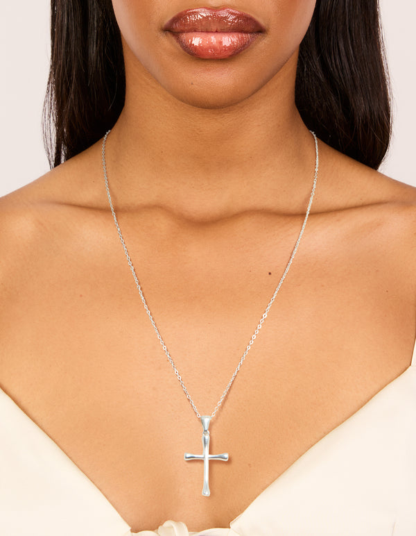 Beautifully designed waterproof stainless steel large cross pendant necklace with charm accents in silver statement styling on neck view