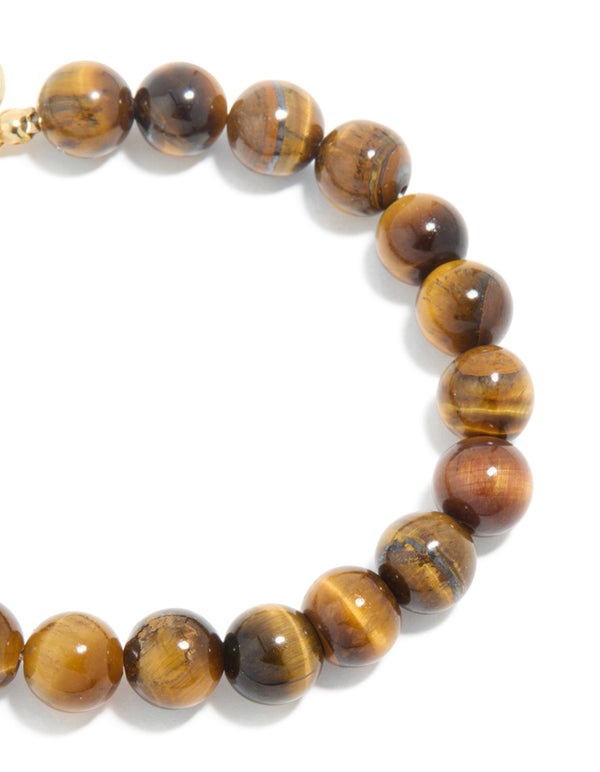 Highlighting beaded details with waterproof gold plated stainless steel and tigers eye semi precious stone bracelet in gold close up view