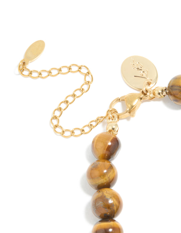 Featuring a beaded bracelet with waterproof gold plated stainless steel and tigers eye semi precious stone in gold closure detail view