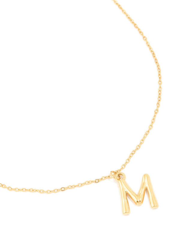 Showcasing a waterproof gold plated stainless steel bamboo letter M dainty style necklace featuring initials pendant close up view