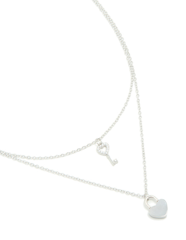 Showcasing a waterproof stainless steel layered necklace featuring key & heart and padlock pendant in silver close up view