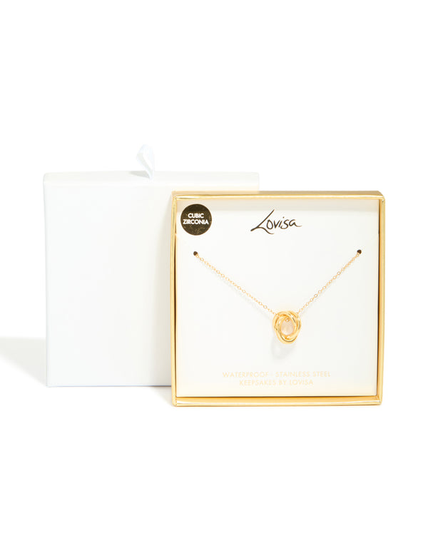 Featuring a waterproof triple circle link necklace in stainless steel with cubic zirconia and gold plated detail close up view