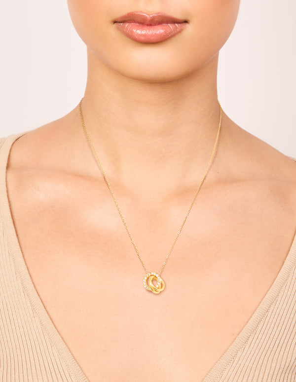 Showcasing a waterproof triple circle link necklace crafted from stainless steel with cubic zirconia in gold plated finish on neck view