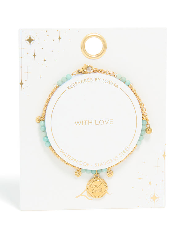Presenting a waterproof beaded bracelet crafted from gold plated stainless steel, featuring aquamarine beads and script charms in a dainty style closure detail view