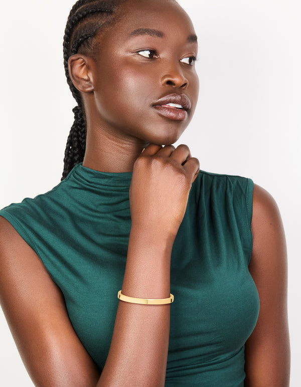 Crafted from waterproof gold plated stainless steel toggle bangle on model view