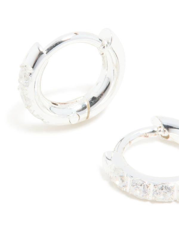 Crafted from waterproof stainless steel with cubic zirconia huggie earrings in silver and clear close up view