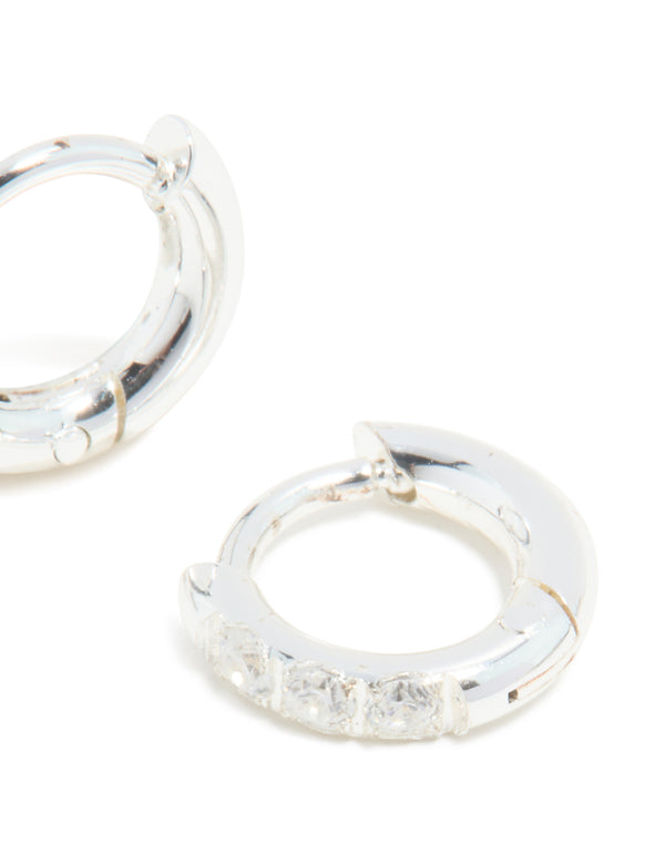 Designed with waterproof stainless steel cubic zirconia huggie earrings in silver and clear post detail view