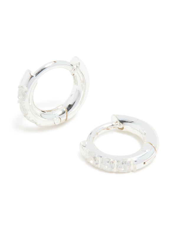 Showcasing waterproof stainless steel cubic zirconia huggie earrings in silver with clear stones front view