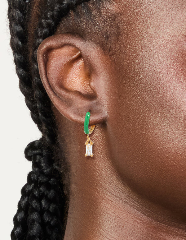 Featuring waterproof gold plated stainless steel emerald green enamel cubic zirconia huggie earrings on ear view