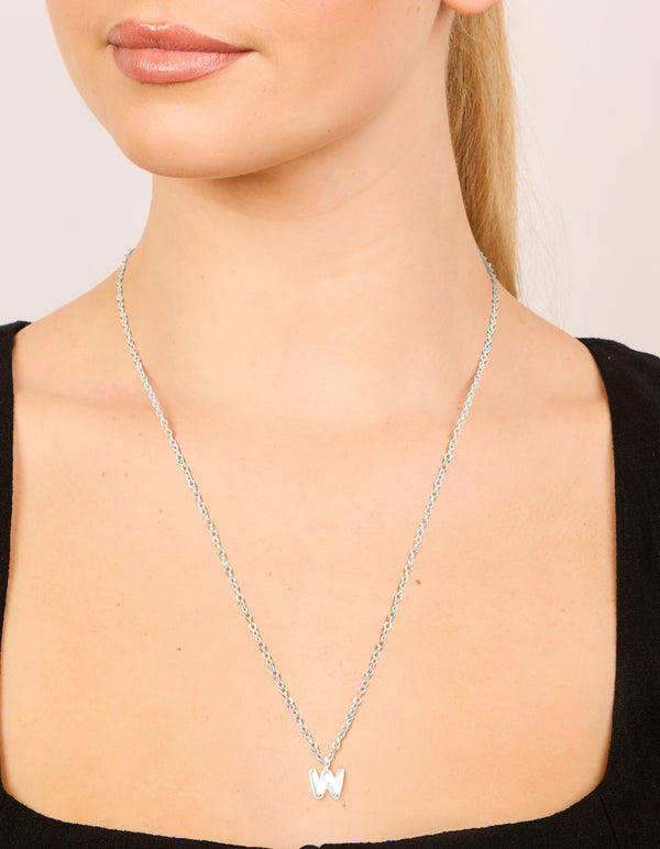 Elegant waterproof stainless steel mini bubble letter W necklace pendant in silver on neck view