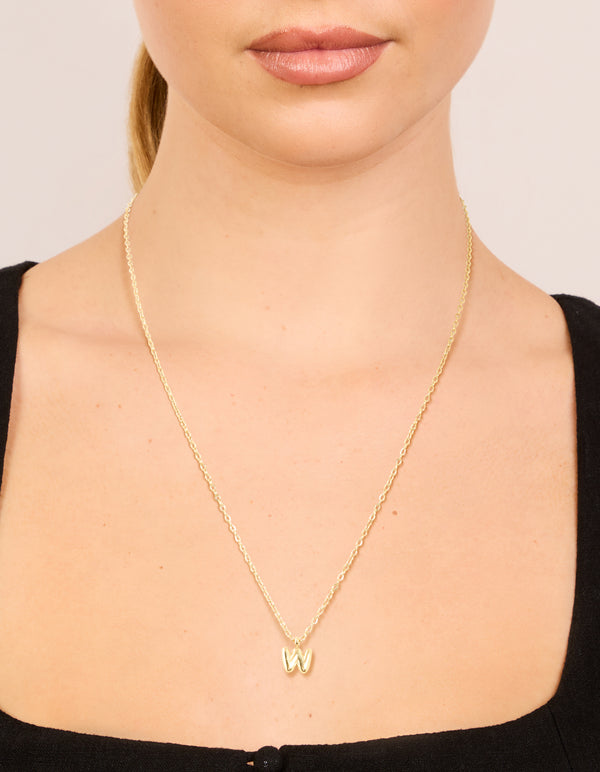 Showcasing waterproof mini bubble letter W necklace with initial pendant in stainless steel featuring plated finish on neck view