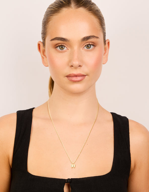 Elegant waterproof mini bubble letter W necklace with initial pendant crafted from stainless steel in plated finish on model view