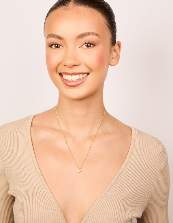 Showcasing a waterproof initial letter Y necklace in gold plated stainless steel with pendant featuring dainty style on model view