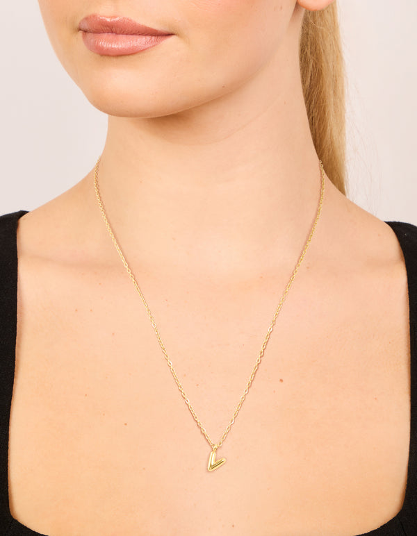 Showcasing waterproof mini bubble letter V necklace with initials pendant in gold plated stainless steel on neck view