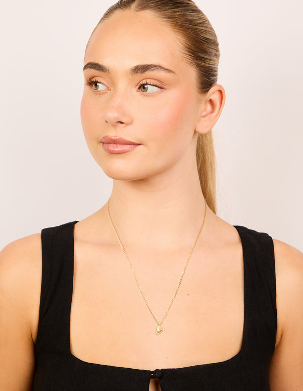 Featuring waterproof mini bubble letter V necklace with initials pendant in gold plated stainless steel on model view