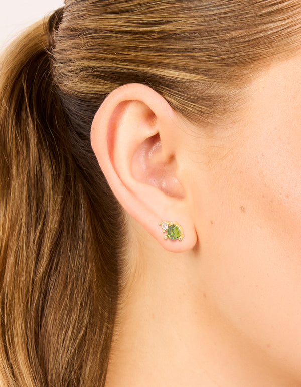 Featuring waterproof gold plated stainless steel August cubic zirconia birthstone duo stud earrings on ear view