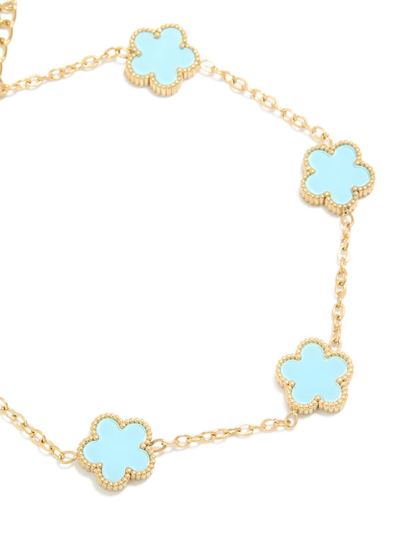 Crafted from waterproof gold plated stainless steel light blue petal flower charm bracelet in powder blue and gold close up view