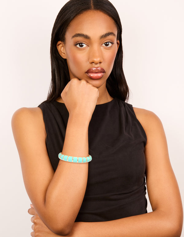 Beautifully styled aqua enamel stripe bangle in gold on model view