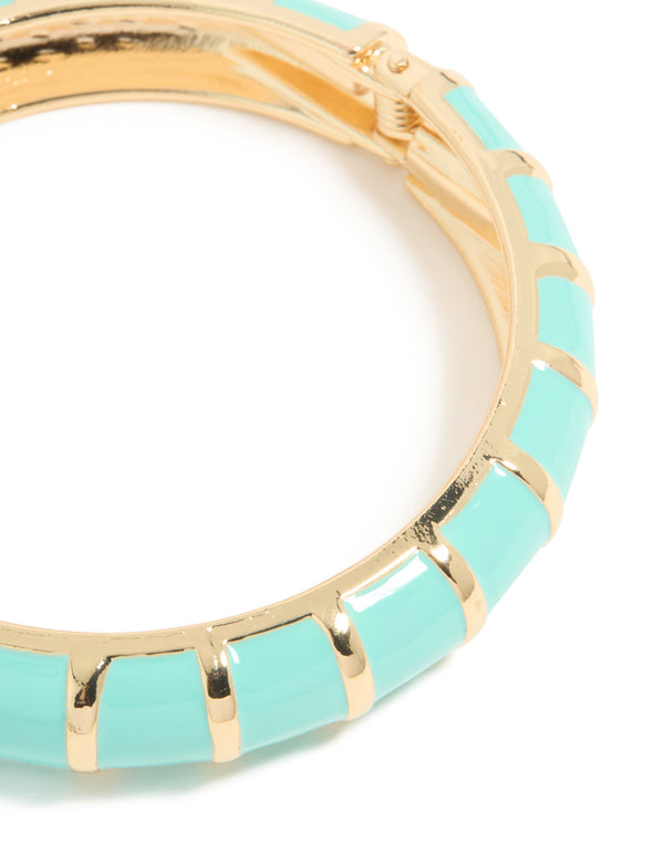 Highlighting an aqua enamel stripe bangle in gold with closure detail view