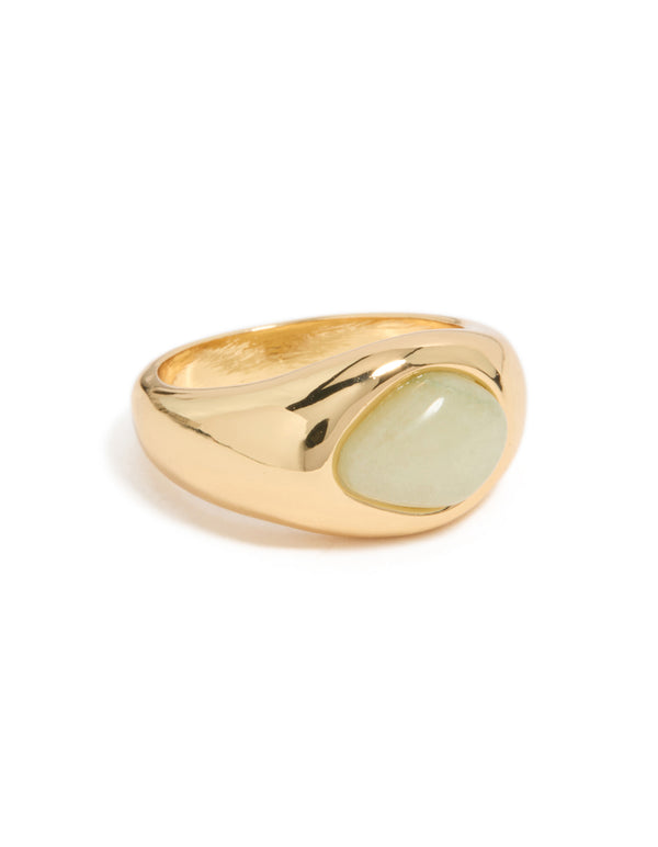 Featuring a gold plated ring with pale green oval stone in a statement style on finger view