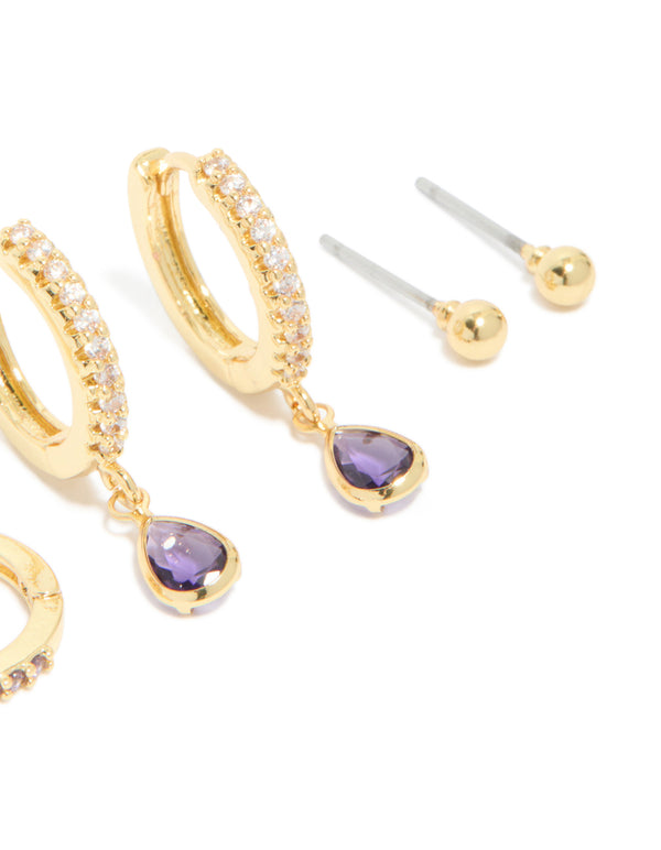Showcasing gold plated brass amethyst cubic zirconia February birthstone earrings in a 4-pack with ball stud, hoop, and huggie closures featuring crystal accents close up view